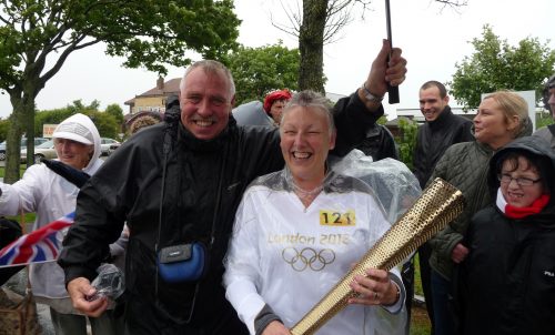 Sue, a founder member and trustee of Paddlers for Life carries the Olympic Torch in Blackpool.