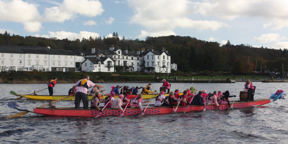 Who is leading in the 'Pink Paddle' race between Paddlers for Life and Low Wood Hotel staff.2011