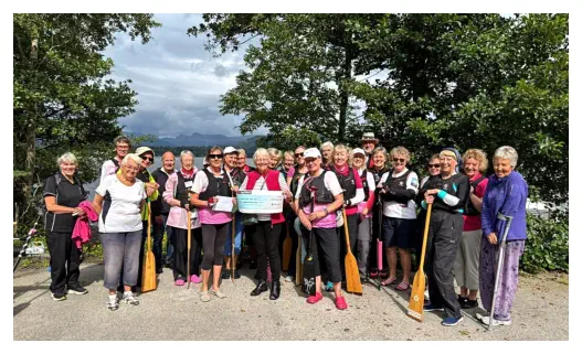 A group from 2025 at a cheque presentation. Can you see a member who is in all three photos?